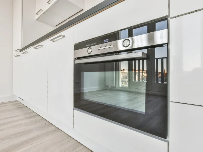 Interior design of an empty kitchen with a white kitchen set