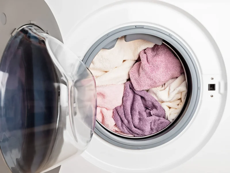 Washing or drying machine loaded with the laundry. Washing, spring cleaning idea