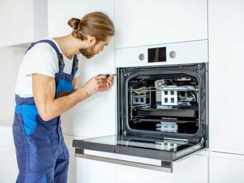 Workman installing kitchen oven